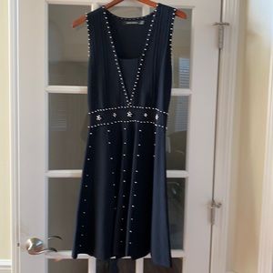 Black dress embellished with gold studs